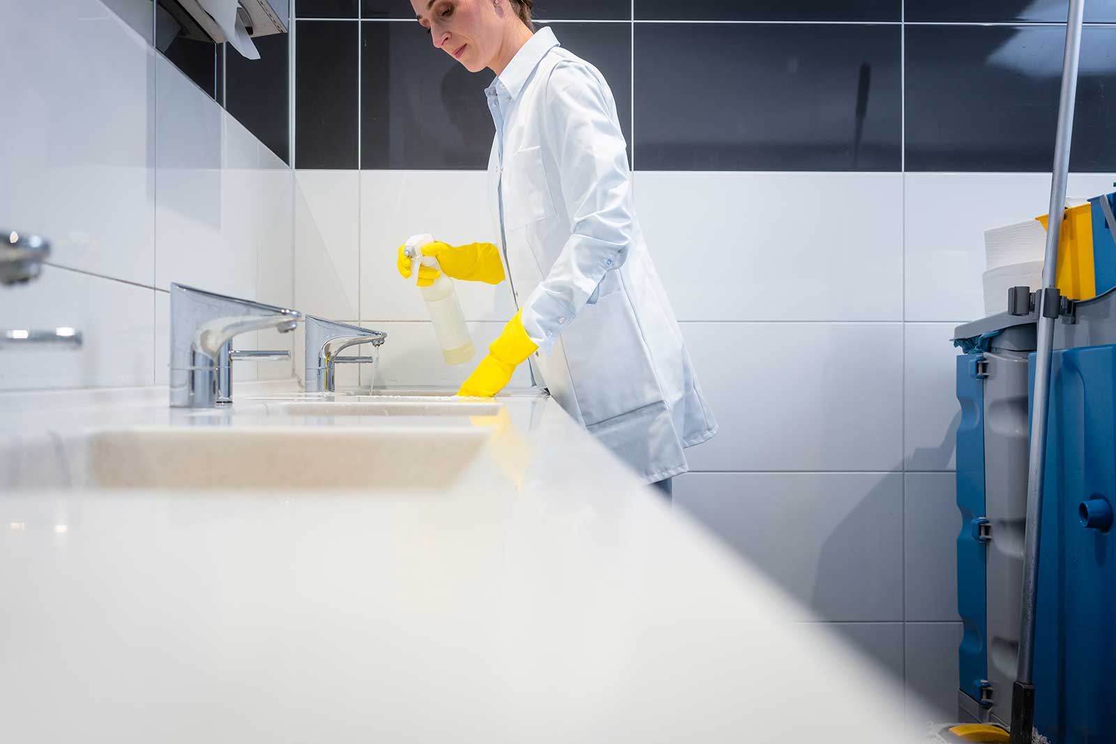 femme de menage nettoyant une salle de bain